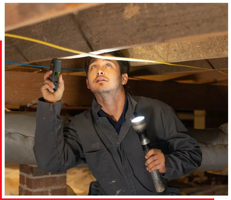 technician checking moisture in crawl space